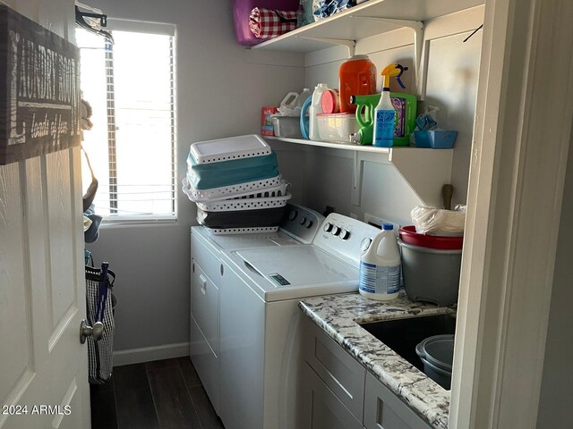 laundry area with cabinets, dark hardwood / wood-style floors, independent washer and dryer, and sink