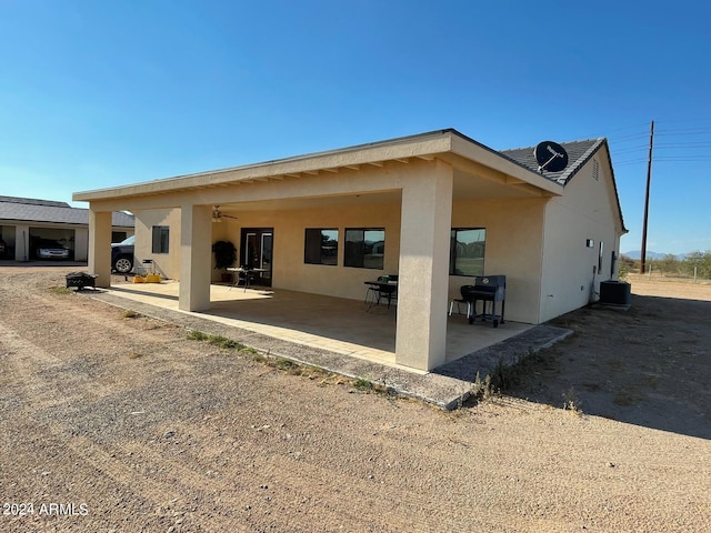 rear view of property featuring central AC and a patio