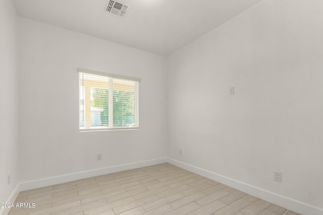 spare room featuring light wood-type flooring