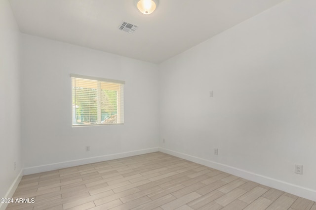 empty room with light hardwood / wood-style flooring