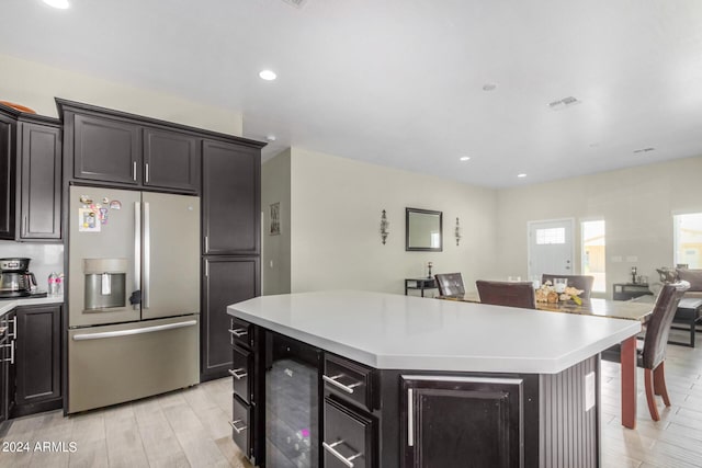 kitchen featuring light hardwood / wood-style flooring, stainless steel fridge, and a center island