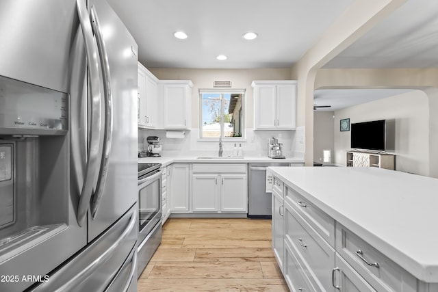 6819 N 10th Pl, Phoenix, AZ 85014 - kitchen with appliances with stainless steel finishes, a sink, light wood finished floors, light countertops, and recessed lighting