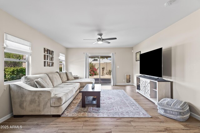 6819 N 10th Pl, Phoenix, AZ 85014 - living area featuring plenty of natural light, ceiling fan, wood finished floors, and baseboards