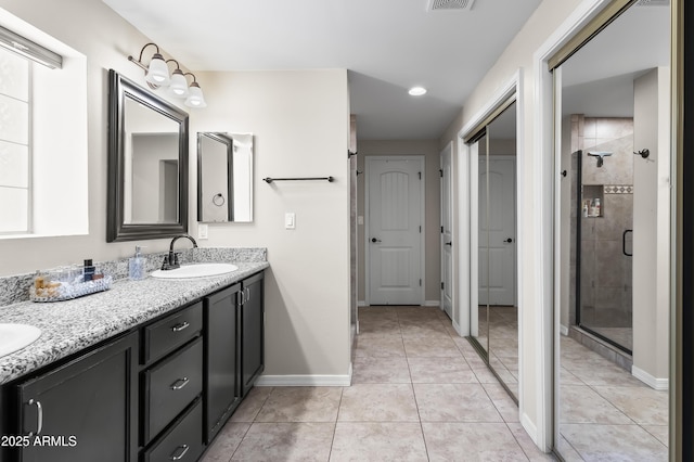 6819 N 10th Pl, Phoenix, AZ 85014 - full bath with double vanity, a shower stall, baseboards, and tile patterned flooring