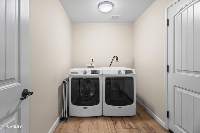 6819 N 10th Pl, Phoenix, AZ 85014 - laundry room with washing machine and clothes dryer, baseboards, and wood finished floors