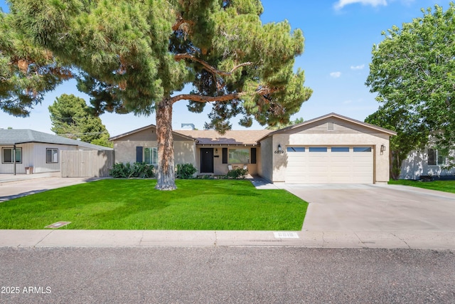 6819 N 10th Pl, Phoenix, AZ 85014 - ranch-style home with an attached garage, driveway, stucco siding, and a front yard