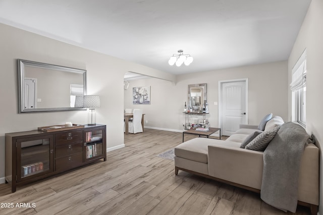 6819 N 10th Pl, Phoenix, AZ 85014 - living area featuring wood finished floors, baseboards, and arched walkways