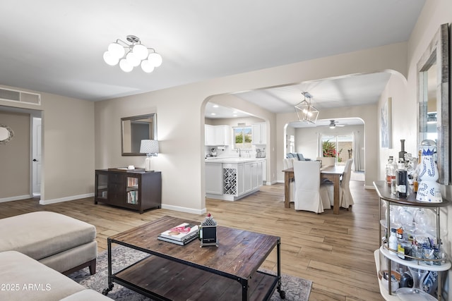 6819 N 10th Pl, Phoenix, AZ 85014 - living area featuring arched walkways, light wood-style floors, and a ceiling fan