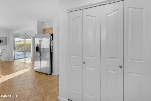 hall featuring light tile patterned flooring