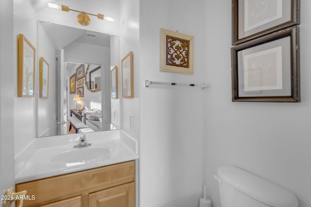 bathroom with vanity and toilet