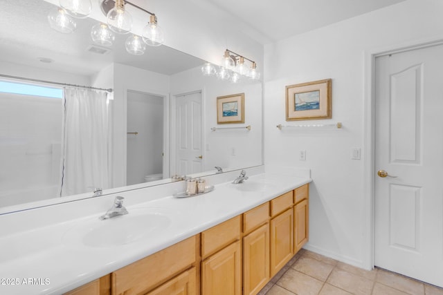 bathroom featuring vanity, a shower with shower curtain, tile patterned floors, and toilet