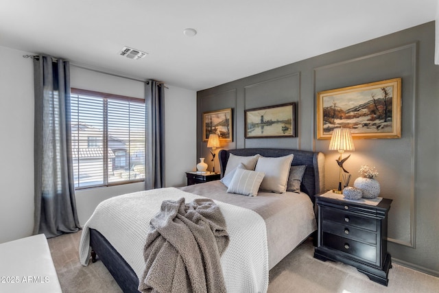 bedroom featuring light carpet