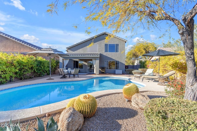 view of swimming pool featuring a patio area and a fire pit