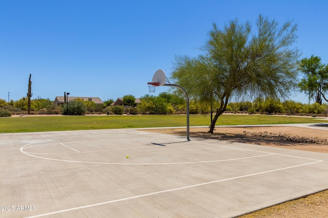 view of sport court featuring a yard