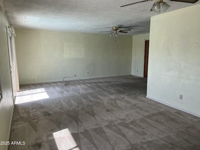 unfurnished room with a ceiling fan, carpet, a textured ceiling, and baseboards