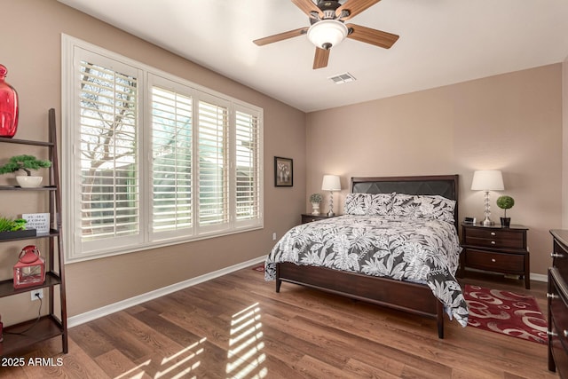 bedroom with ceiling fan and hardwood / wood-style flooring