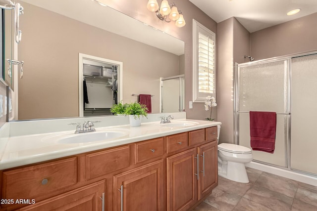 bathroom with toilet, an enclosed shower, tile patterned floors, and vanity