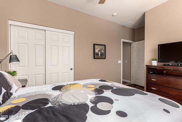 bedroom with ceiling fan and a closet