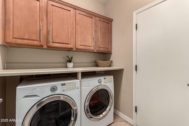 washroom featuring cabinets, light tile patterned floors, and independent washer and dryer