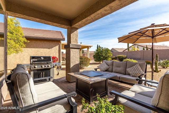 view of patio / terrace featuring area for grilling and an outdoor living space with a fire pit