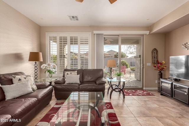 tiled living room featuring ceiling fan