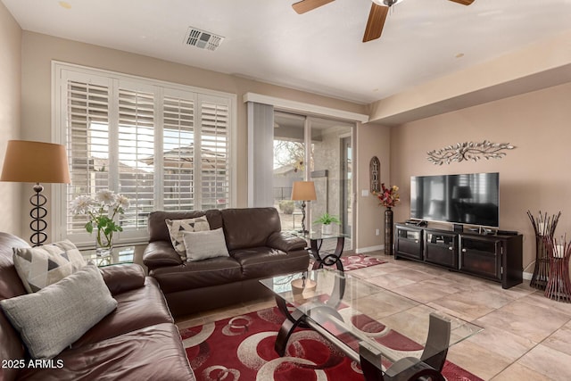 tiled living room with ceiling fan