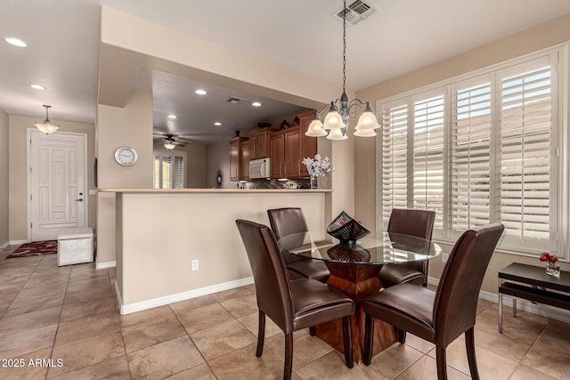 dining space with ceiling fan and light tile patterned floors