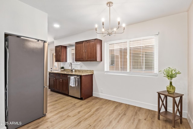 2015 E Southern Ave Unit 16, Tempe, AZ 85282 - kitchen with stainless steel appliances, light wood-type flooring, a chandelier, decorative light fixtures, and light stone counters