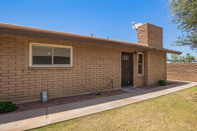 2015 E Southern Ave Unit 16, Tempe, AZ 85282 - view of exterior entry with a chimney