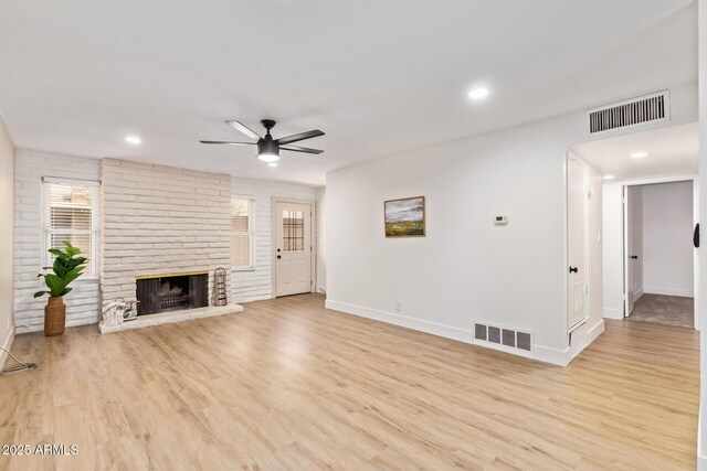 2015 E Southern Ave Unit 16, Tempe, AZ 85282 - unfurnished living room featuring a ceiling fan, plenty of natural light, wood finished floors, a fireplace, and recessed lighting