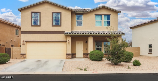 view of front of property with stucco siding, an attached garage, fence, and a tiled roof