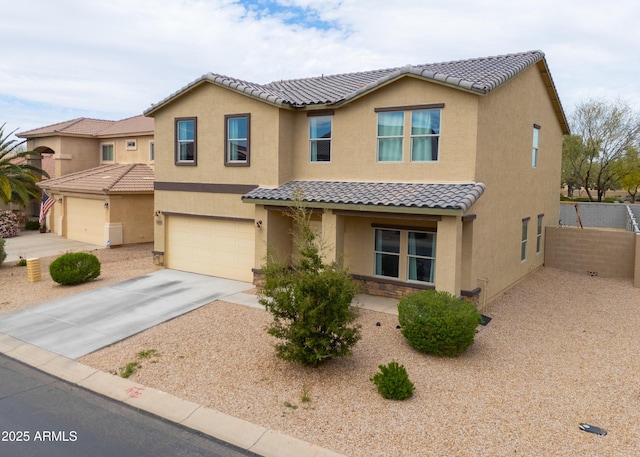 view of front of house featuring stucco siding, fence, an attached garage, a tiled roof, and driveway