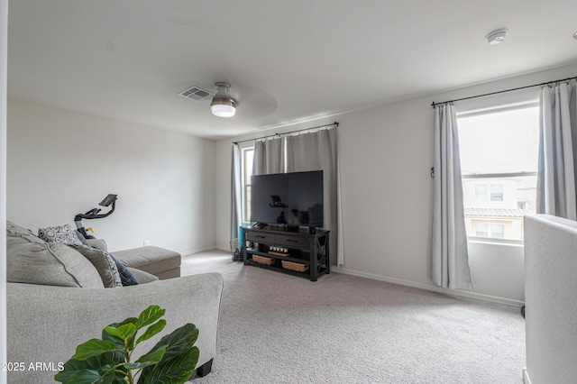 living room featuring baseboards, visible vents, and carpet flooring