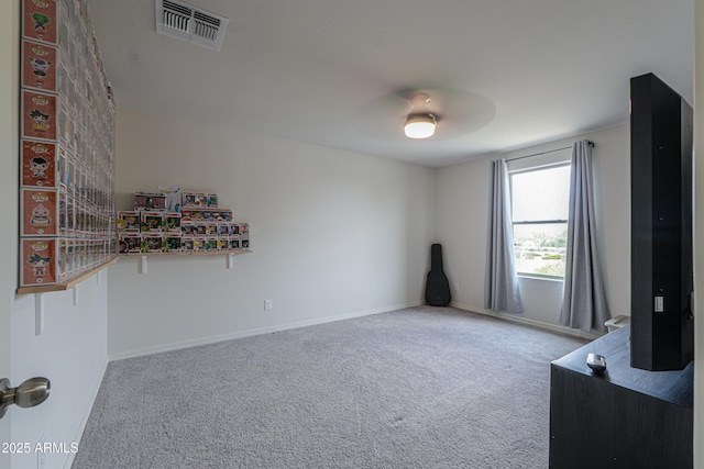interior space featuring baseboards, visible vents, ceiling fan, and carpet floors