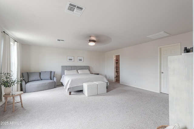 bedroom featuring a spacious closet, carpet, and visible vents