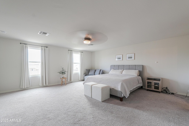 bedroom featuring baseboards, visible vents, ceiling fan, and carpet floors