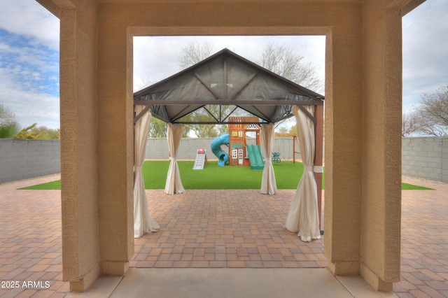 view of patio / terrace with a fenced backyard and playground community