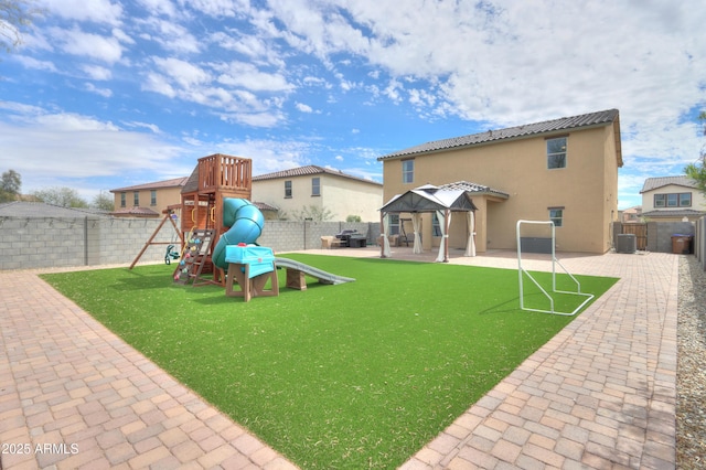 view of play area featuring a fenced backyard, a gazebo, and a patio