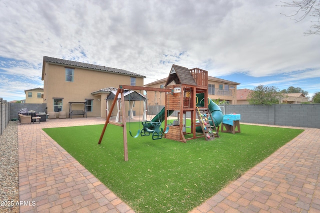 view of play area featuring a patio and a fenced backyard