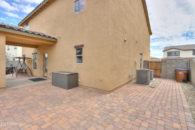 view of patio / terrace with central AC and fence