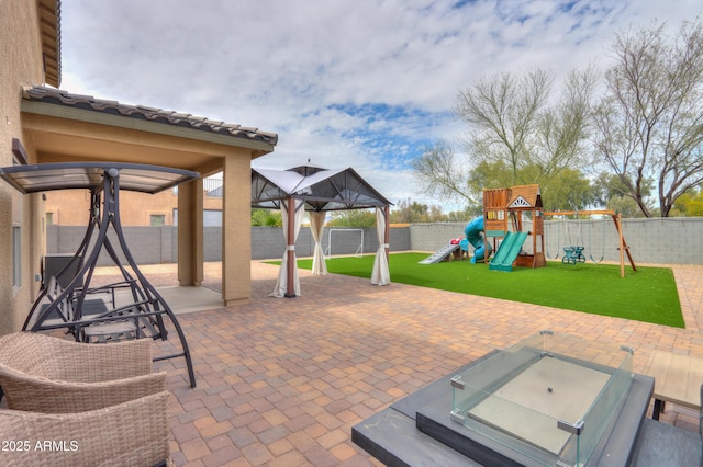 view of patio featuring a fenced backyard, a playground, and a gazebo