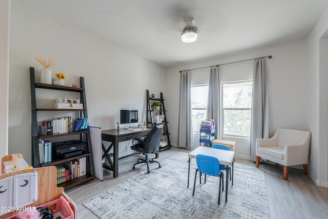 office featuring baseboards and wood finished floors