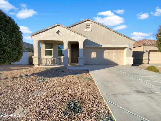 view of front of property featuring a garage and a porch