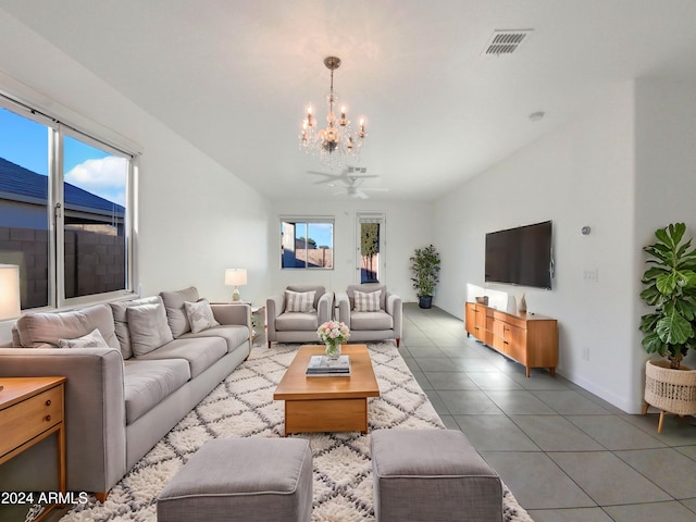 living room with vaulted ceiling, tile patterned floors, and ceiling fan with notable chandelier