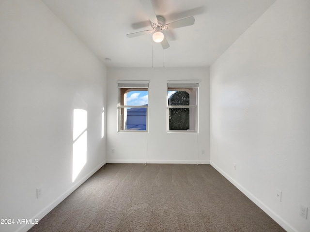 carpeted empty room featuring ceiling fan