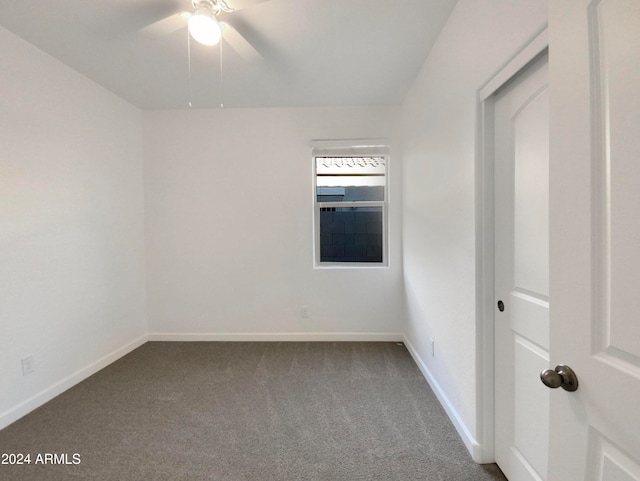 empty room with ceiling fan and carpet floors