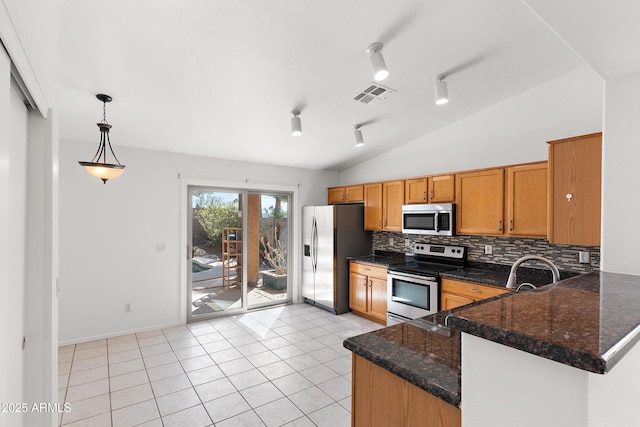 kitchen with light tile patterned floors, lofted ceiling, visible vents, decorative backsplash, and appliances with stainless steel finishes