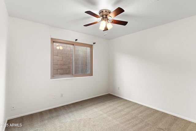 unfurnished room featuring carpet, a ceiling fan, and baseboards