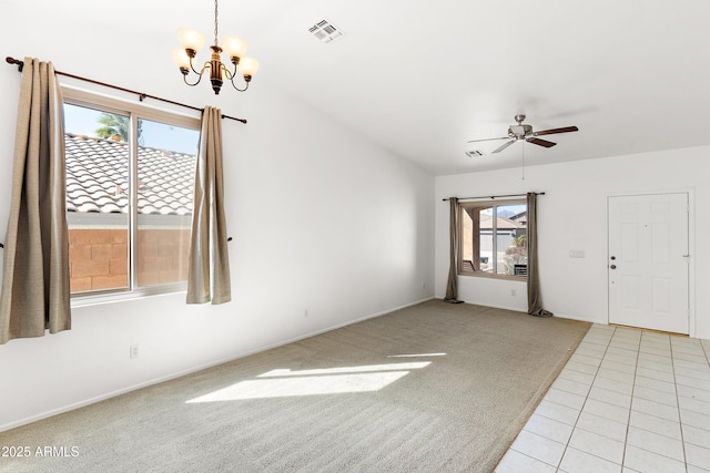 unfurnished room featuring light tile patterned floors, ceiling fan with notable chandelier, visible vents, and light colored carpet