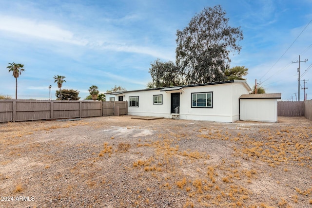 back of house featuring a fenced backyard